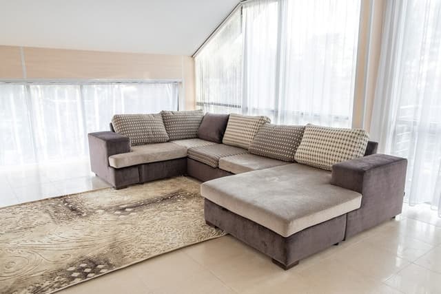 C-Shaped Grey Sofa in a White Setup