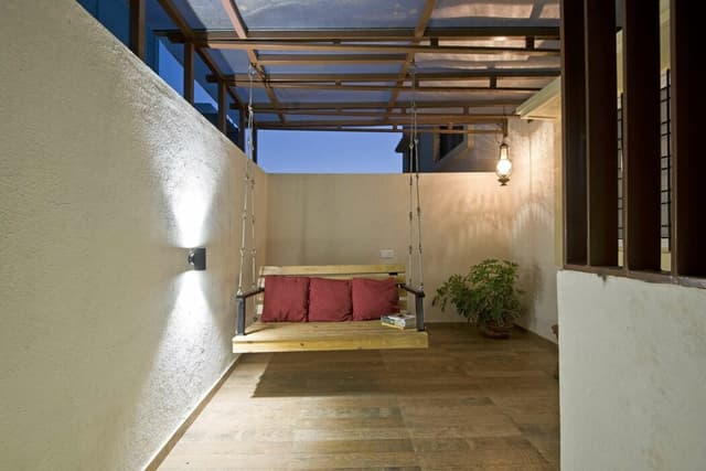 Verandah with Wooden Flooring and Creme-Painted Walls