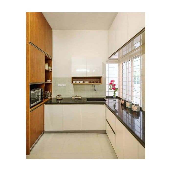 Spacious Kitchen with an L-Shaped Black Granite Countertop
