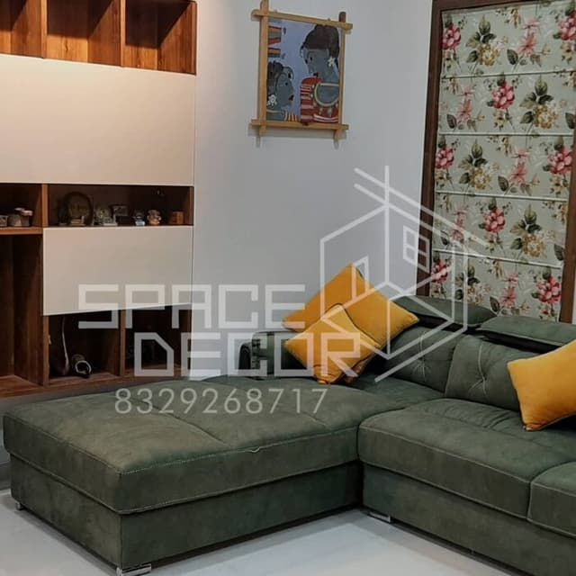 Living Room Featuring a Plush L-Shaped Green Sofa