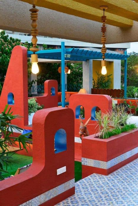Home-Garden-on-Terrace-Floor-having-Parapet-Wall-with-Red-Wall-Paint-having-Voids-with-Blue-Wall-Paint-8 Design Detail Banner 6