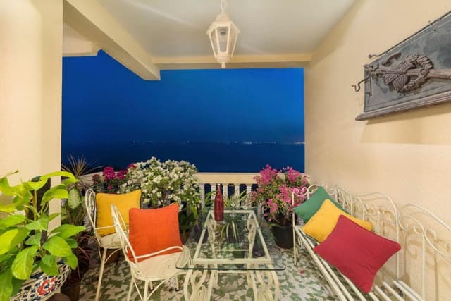 The-Terrazzo-Flooring-White-Metal-Chairs-Bench-Style-Seating-are-Making-this-Compact-Balcony-Vibrant. Balcony Decoration With Plants