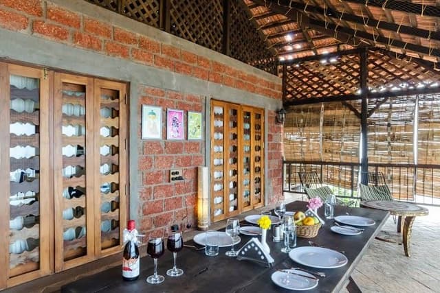 This-Vernacular-Semi-Covered-Balcony-has-a-Portable-Wooden-Dining-Table-with-Bench-Style-Sitting. Balcony