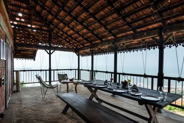 This-Vernacular-Semi-Covered-Balcony-has-a-Portable-Wooden-Dining-Table-with-Bench-Style-Sitting Portable Wooden Dining Table