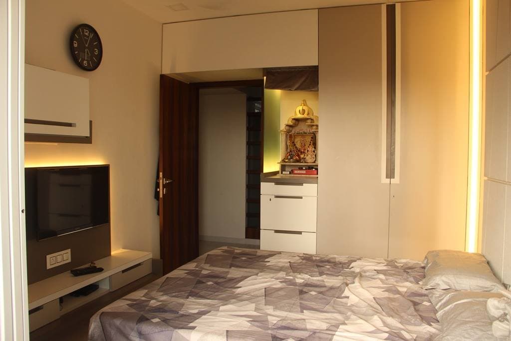 The Bedroom consists of Rectangular Wooden Bed & Wall Mounted T.V. Unit The Bedroom consists of Rectangular Wooden Bed & Wall Mounted T.V. Unit