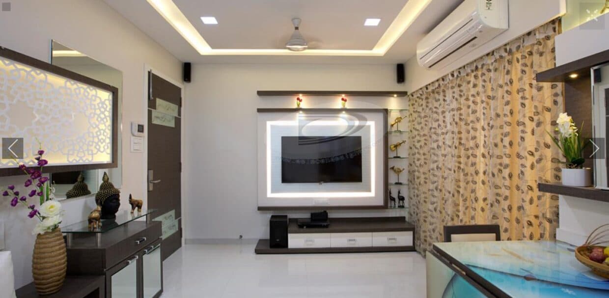 The Compact Living Room with White & Brown Combination has L Shaped White Upholstered Sofa with Wooden Side Table cum Storage Unit – 1 The Compact Living Room with White & Brown Combination has L Shaped White Upholstered Sofa with Wooden Side Table cum Storage Unit - 1