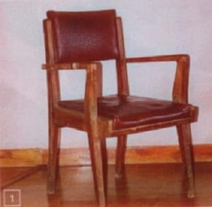 Old and dull wooden chair with cracked upholstery
