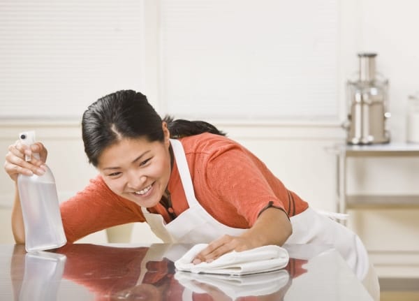 Women Cleaning Kitchen Countertop for germ free home