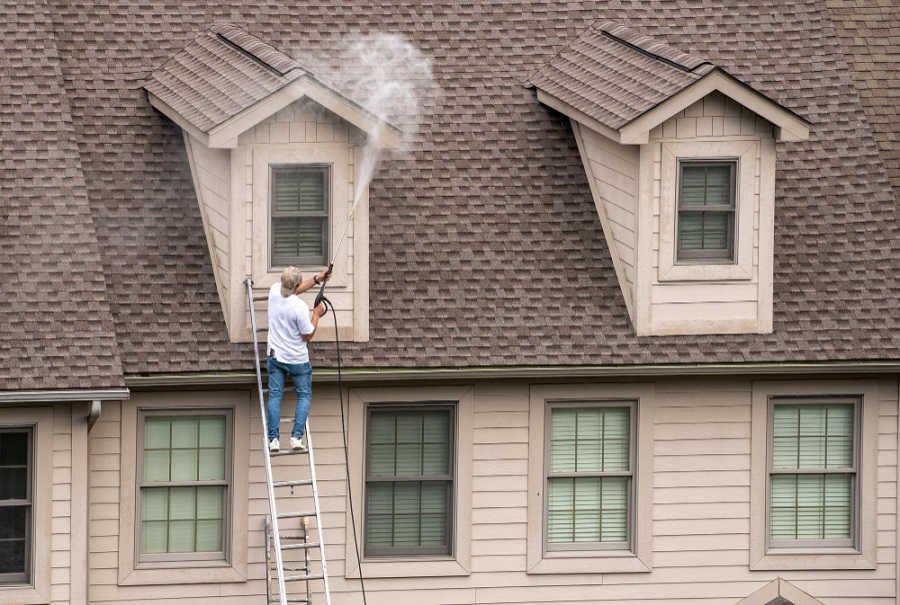 Pressure washing the exterior of house