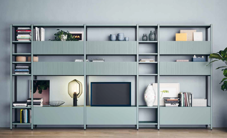 A-Free-Standing-Metal-Frame-T.V.-Unit-on-Wheels-in-Light-Grey-Colour-with-Linear-Bookshelves-and-enclosed-Cabinets-for-Books-Lamp-Framed-Painting-Indoor-Plants-Vases-and-other-Decor-Items.