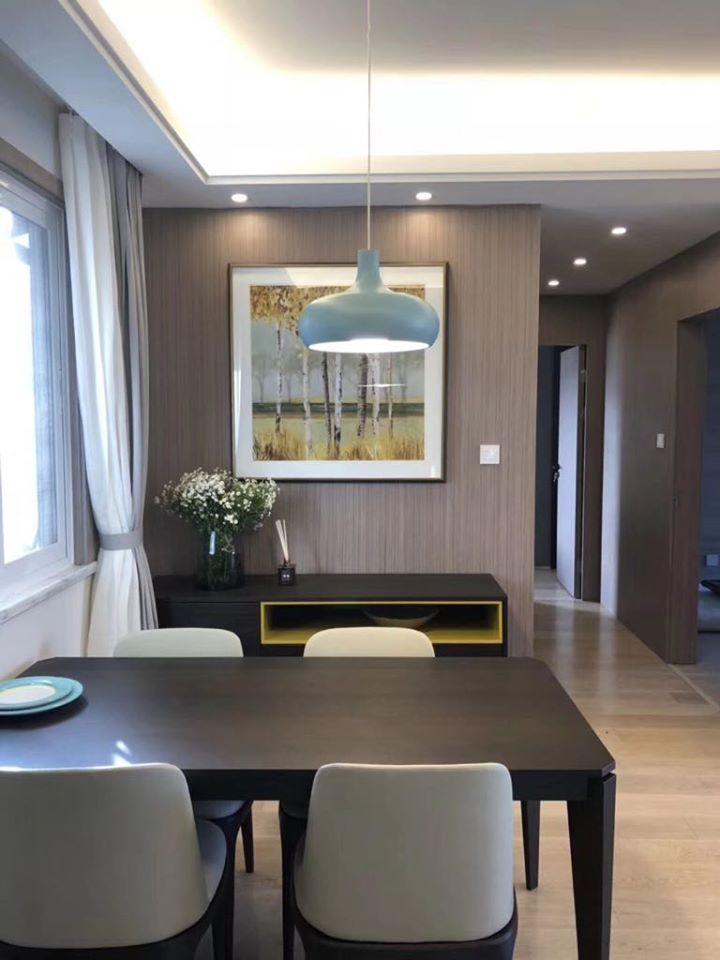 A-Small-Dining-Area-with-4-Seater-Dining-Wooden-Table-with-Chairs-Pendant-Light-Above-Sideboard-with-a-Flower-Vase-on-top-of-it