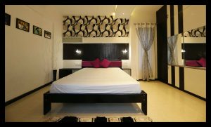 Bedroom with Wooden Bed Attached Side Tables