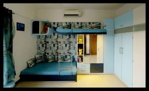 Blue-Themed-Children-Bedroom-accommodating-a-Custom-made-Wooden-Bunkbed-with-SS-Ladder-Adjoining-Dressing-Unit-with-Drawers-Mirror-Open-Display-Boxes-for-Toys