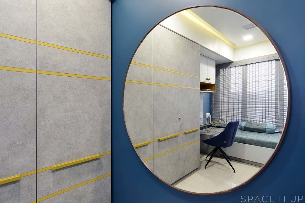 Dressing Area with Oversized Circular Wall Mounted Mirror Ceiling Fitted Wooden Wardrobe with Attached Study Table with Glass Top Wall Mounted Wooden Storage Cabinet