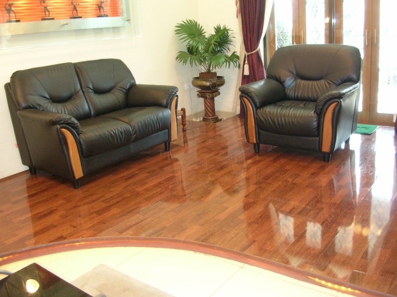 Tufted-Black-Leather-Double-Single-Seater-Sofa-with-Decor-Vase-besides-it-1