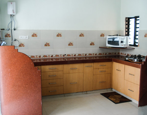 Kitchen with Wooden Cabinets and Brown Granite Countertop