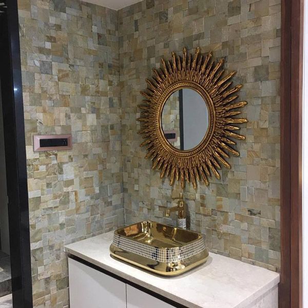 Golden Designer Wash Basin with a Round Decorative Mirror above it