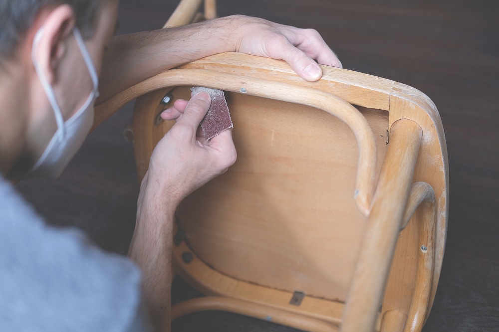 Sanding wooden chair