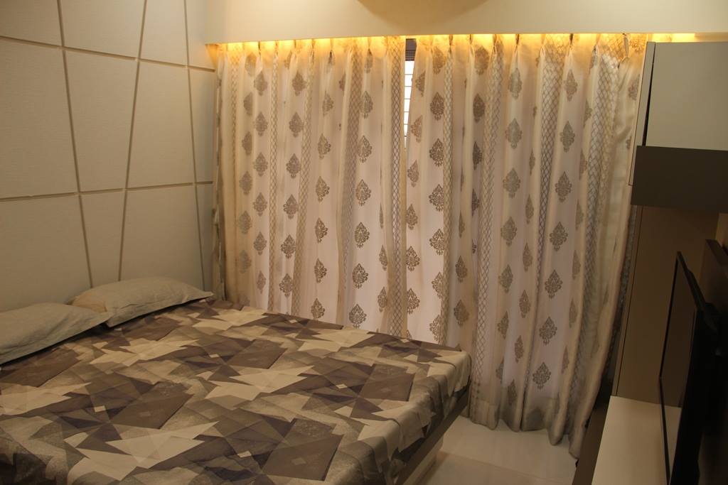The Bedroom consists of Rectangular Wooden Bed & Wall Mounted T.V. Unit - 1