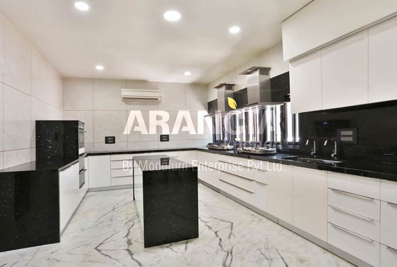 The Black & White themed Kitchen Consists U Shape Black Counter Top