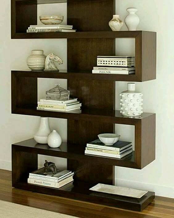 Wooden Shelves having Space for Books is Mounted on White Wall & Making Good Contrast with it