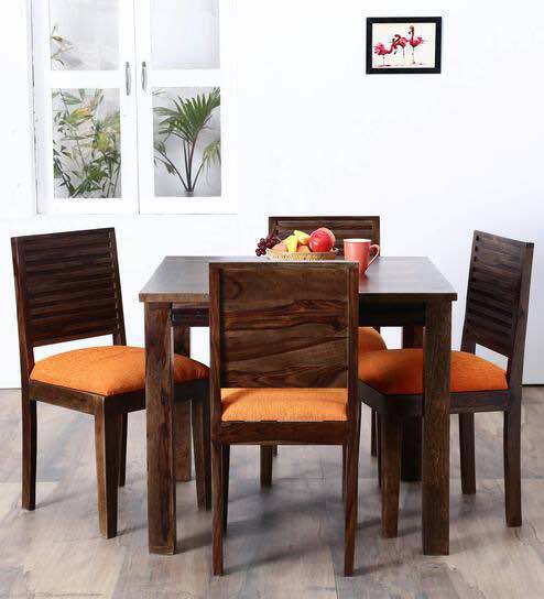A 4 Seater Dining Table has Wooden Table