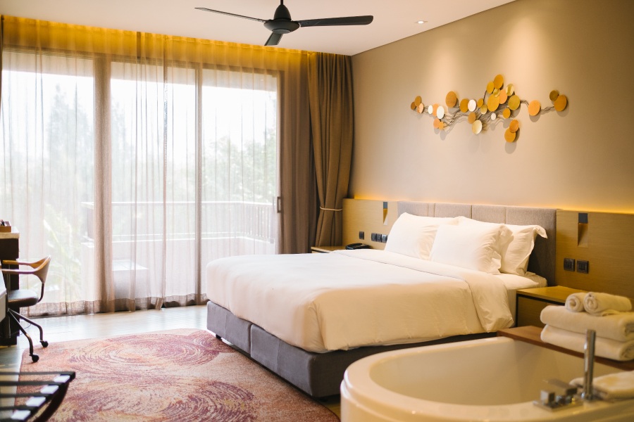 A bedroom with curtains allowing morning sun A bedroom with curtains allowing morning sun