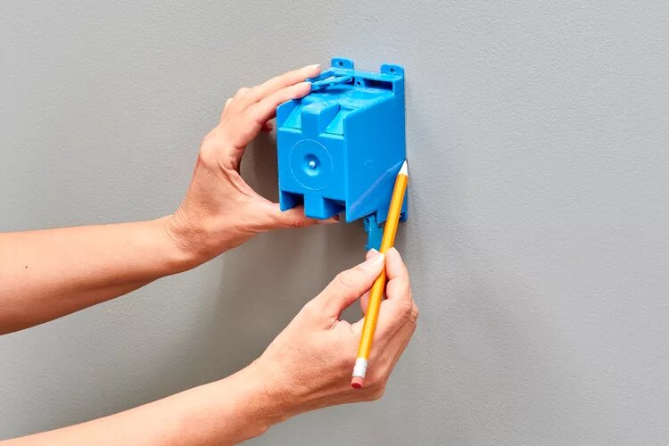 Make a mark and cut a hole for the light switch box