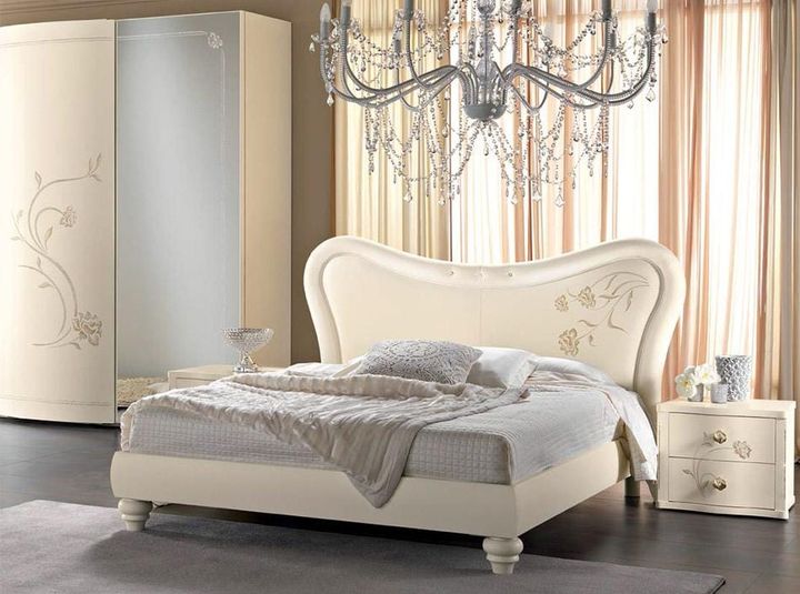 The Bedroom having a Combination of Off White & Grey consists of Ultra luxurious Wooden Bed & Traditional Style Wooden Legs