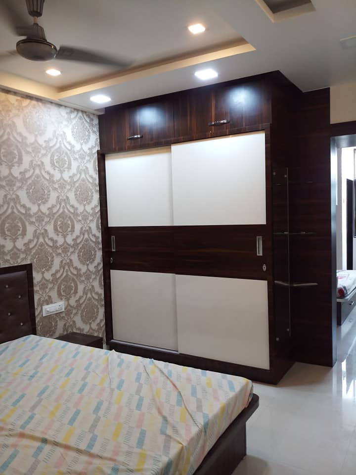 White & Brown coloured 2 Door Sliding Wardrobe with Overhead Storage is alignd to the Wall