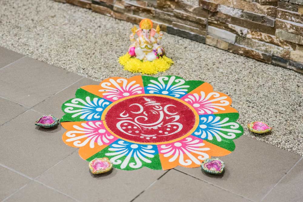 Colourful Rangoli with Diya at Entrance