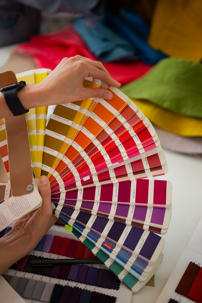 Woman holding a color palette while selecting colors for interior design based on emotional response.