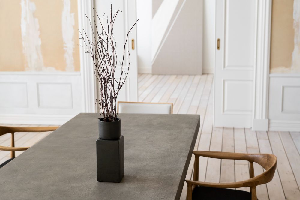 Minimalist interior with concrete furniture and neutral tones creating a clean and balanced space.