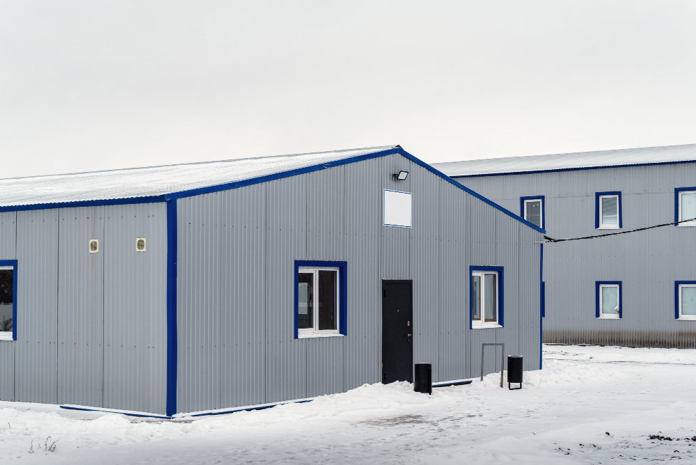 Light Gray Metal Farm Building with Navy Blue Trim