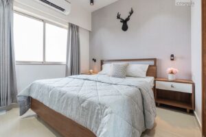 Scandinavian bedroom design with grey walls, wooden headboard, and minimalist decor