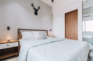 Scandinavian bedroom design with grey walls, wooden headboard, and minimalist decor