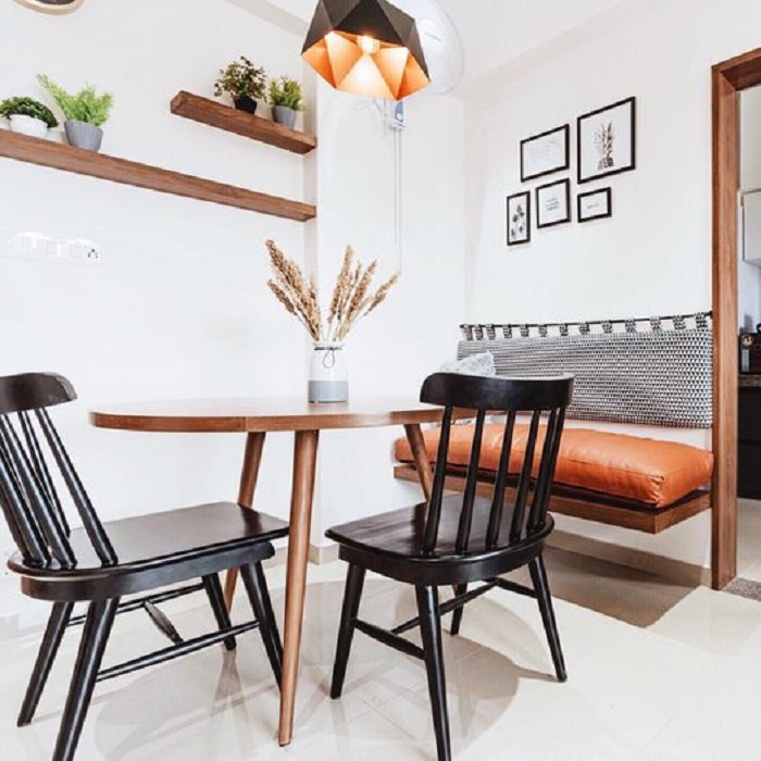Modern dining area with wooden table and black chairs