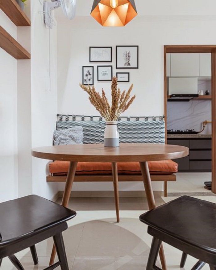 Modern dining area with wooden table and black chairs
