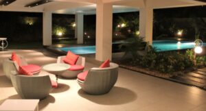 Modern rounded wicker chair with soft red cushions
