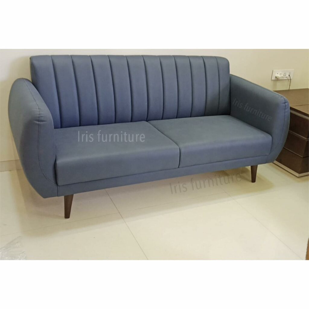 Modern two-seater sofa with soft blue upholstery and tapered wooden legs