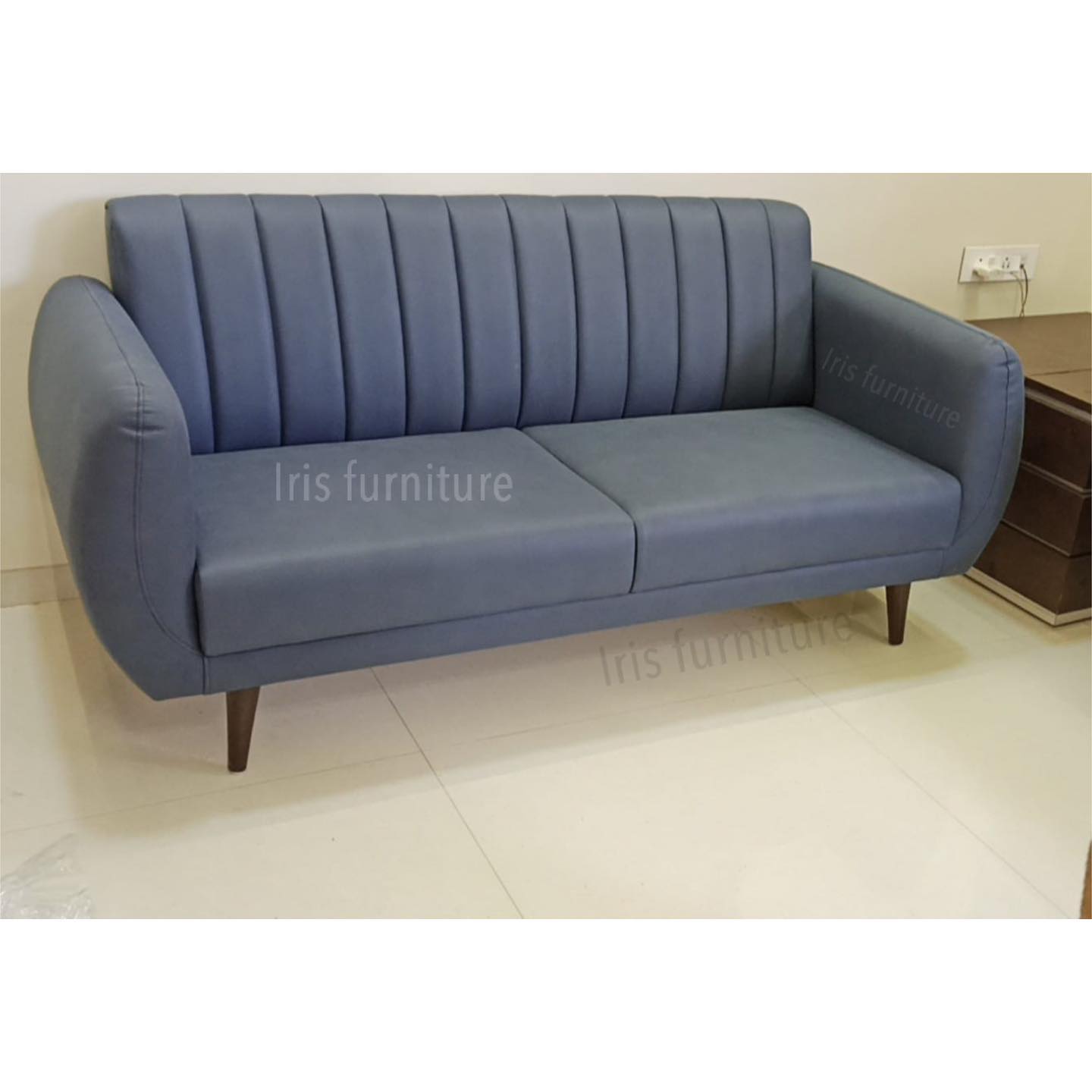 Modern two-seater sofa with soft blue upholstery and tapered wooden legs