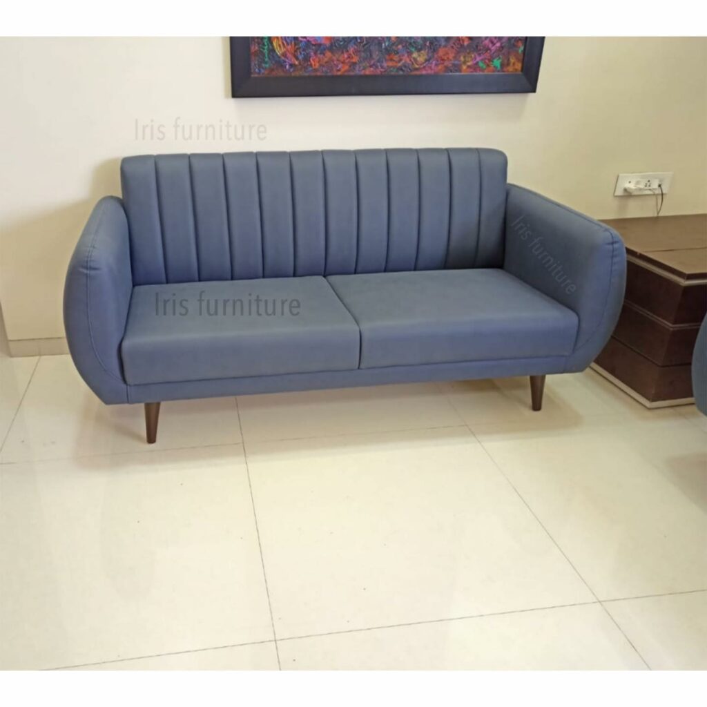 Modern two-seater sofa with soft blue upholstery and tapered wooden legs